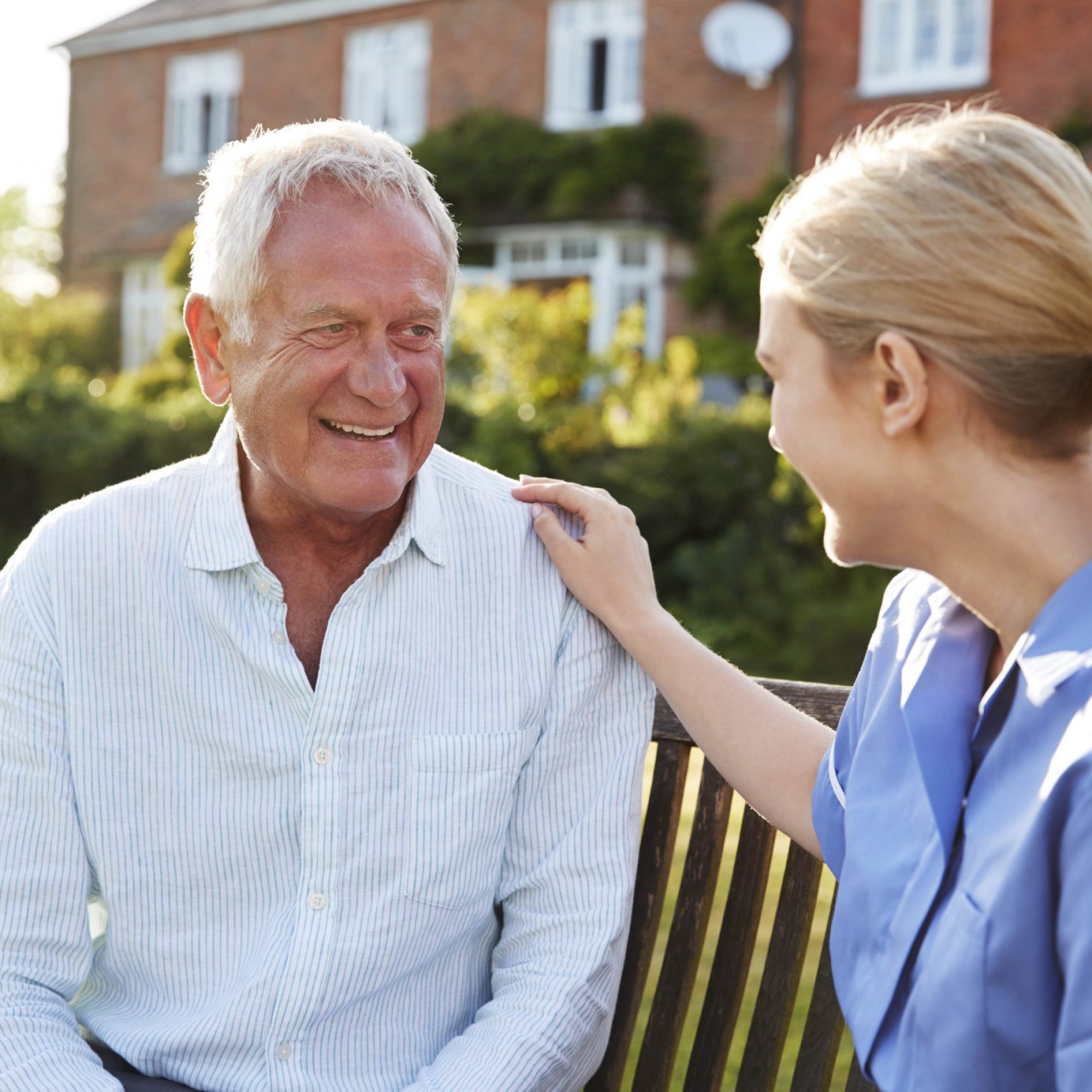 Nurse Talking To Senior Man In Residential Care Home